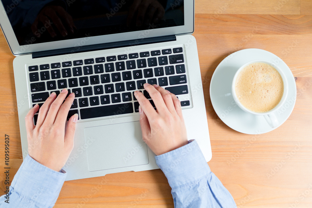 Top view of woman typing on notebook computer Top view of woman typing on notebook computer