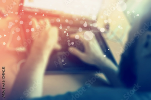 young man working at the computer, blurred background, bokeh
