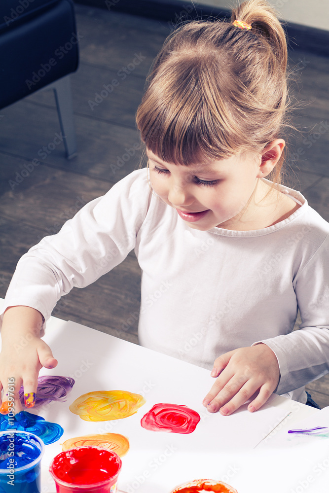 beautiful little girl draws a finger paints beautiful little girl draws a finger paints