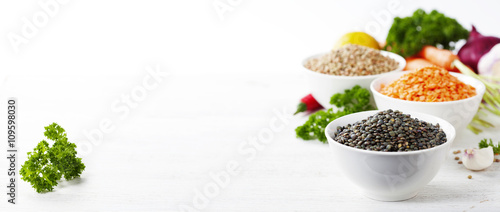 Bowls of assorted dried lentils with vegetables