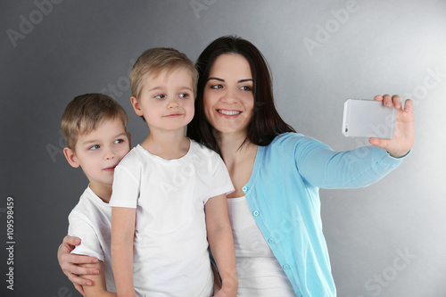 Smiling mom making selfie w...