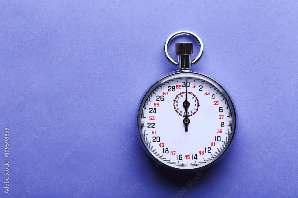 Stopwatch on blue background, close up