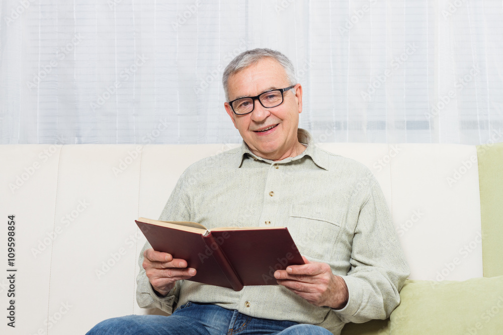 Senior man enjoys reading book. Senior man enjoys reading book.