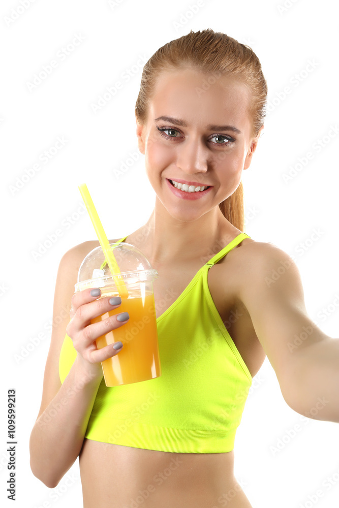 Young woman making selfie photo with plastic cup of orange juice isolated on white Young woman making selfie photo with plastic cup of orange juice isolated on white