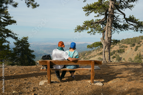 Happy hiking couple on a bench