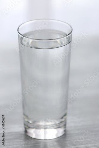 Glass of water on wooden background
