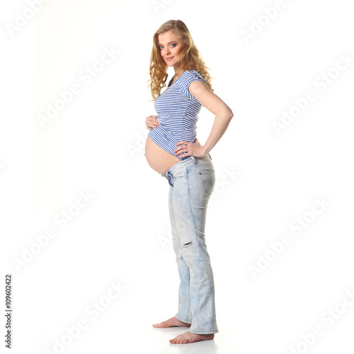 pregnant woman caressing her belly over white background © ruslimonchyk
