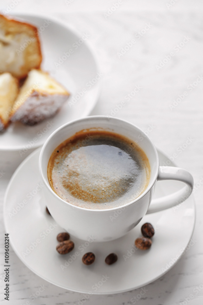 Cup of coffee with cake on light wooden background Cup of coffee with cake on light wooden background