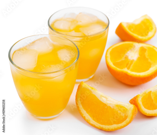Iced orange drink with fresh pieces isolated on white