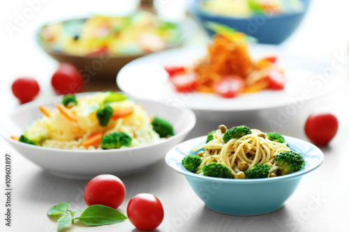 Different cold pasta salads in bowls on the table closeup