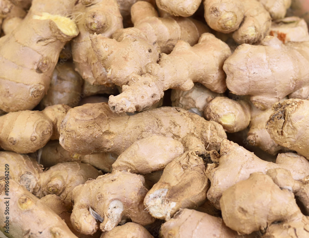 Fresh ginger at a market stall. Selective focus of ginger in a wooden box at a market stall. Fresh ginger at a market stall. Selective focus of ginger in a wooden box at a market stall.