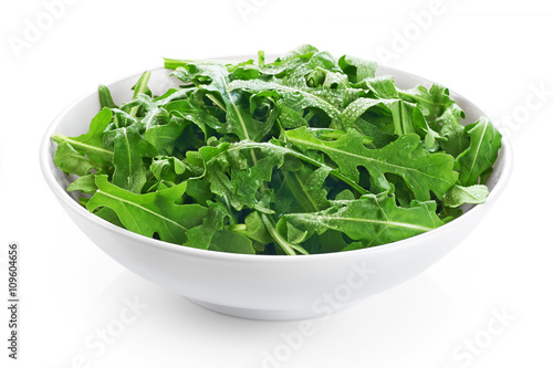 Bowl with fresh green salad arugula isolated on white background