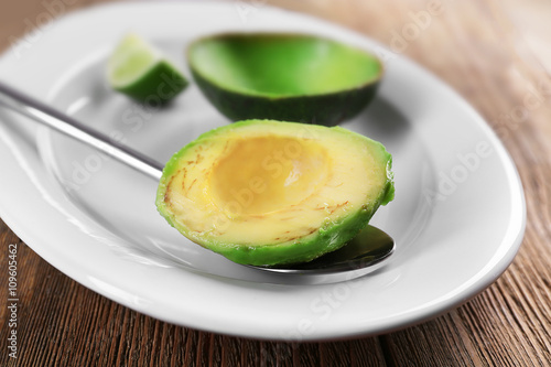 Peeled fresh avocado on plate closeup