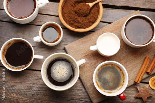 Cups of coffee with spices on wooden table, top view © Africa Studio