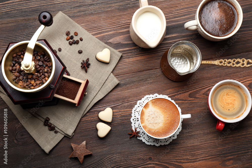 Cups of coffee with beans on wooden table, top view Cups of coffee with beans on wooden table, top view