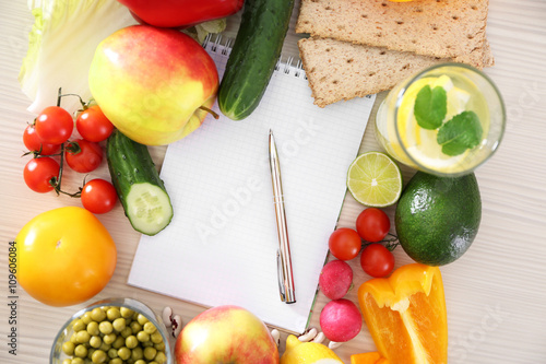 Blank notebook and fresh healthy products on wooden table, top view
