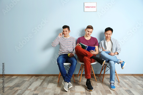 Three men waiting for inter...