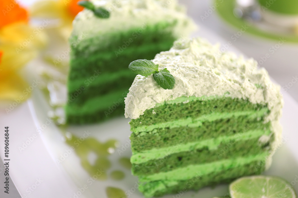 Pieces of delicious creamy lime cake on white plate closeup Pieces of delicious creamy lime cake on white plate closeup