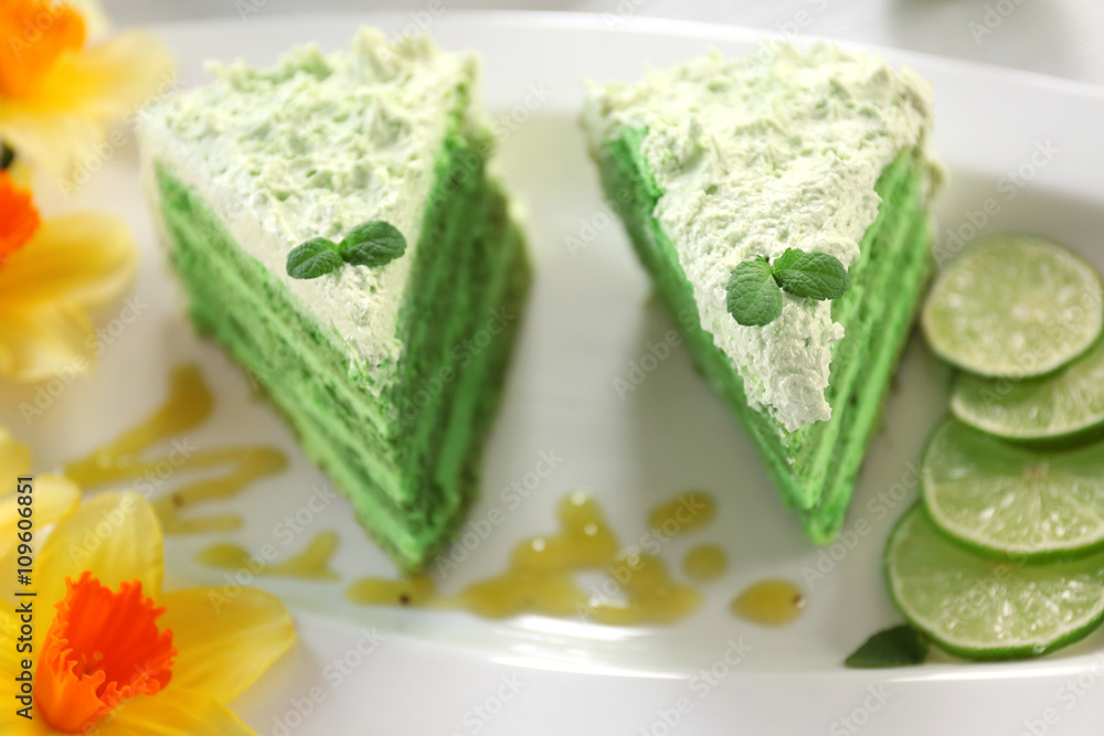 Pieces of delicious creamy lime cake on white plate, top view Pieces of delicious creamy lime cake on white plate, top view