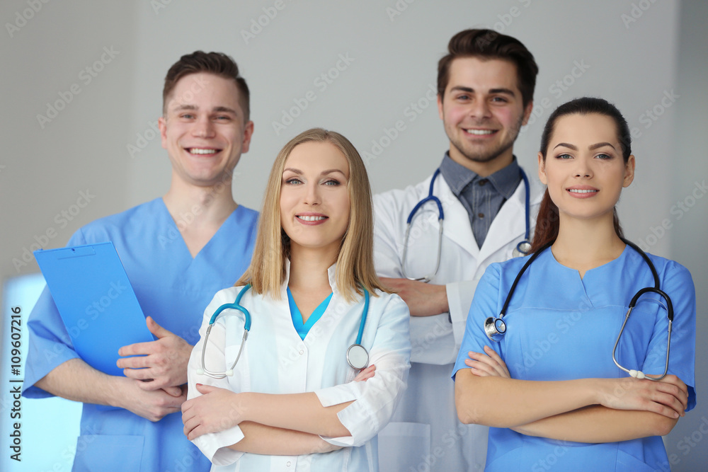 A group of doctors and nurses standing in the hospital, indoors A group of doctors and nurses standing in the hospital, indoors