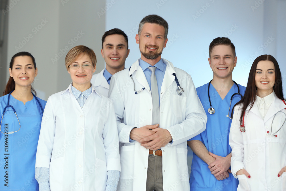 A group of doctors and nurses standing in the hospital, indoors A group of doctors and nurses standing in the hospital, indoors