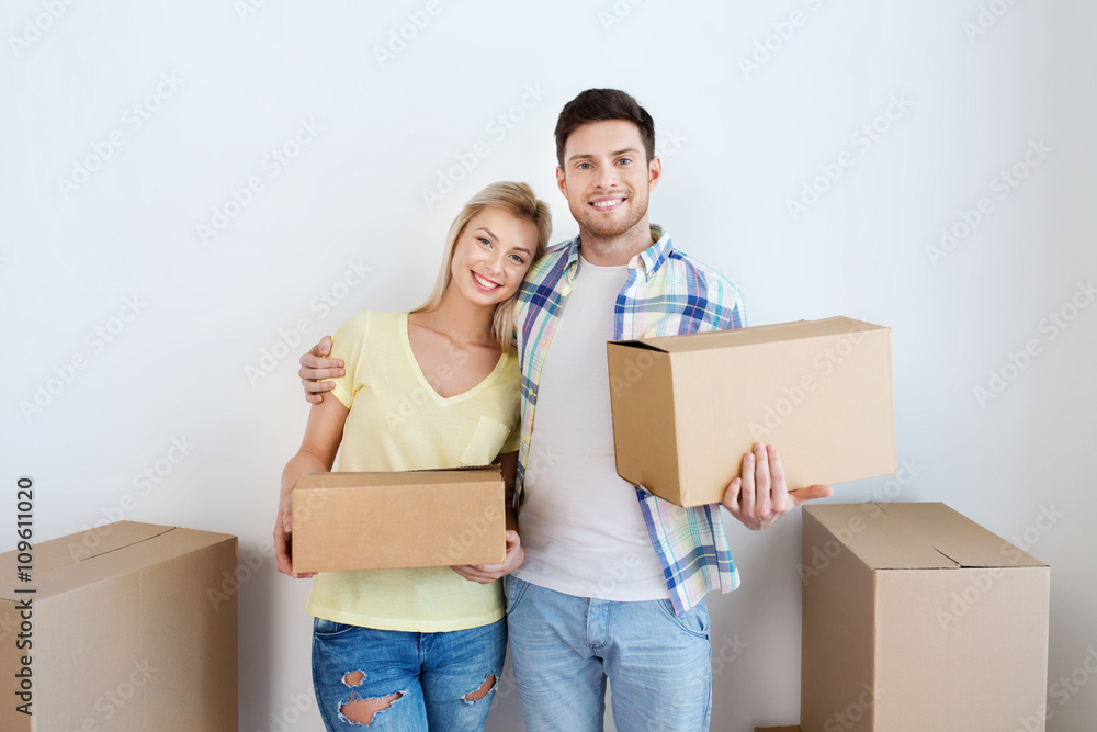 smiling couple with big boxes moving to new home smiling couple with big boxes moving to new home