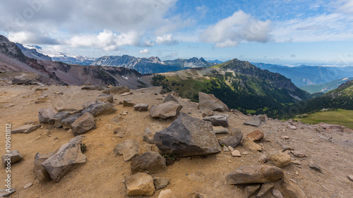 Rocky slopes in the mountains. Amazing view at the peaks which rose against the cloud sky. Path on the tops of mountains. BURROUGHS MOUNTAIN TRAIL  Sunrise Area  Mount Rainier National Park