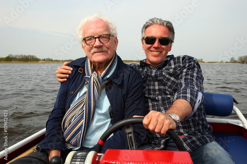 sharing/ fathe and son enjoying a boat ride together