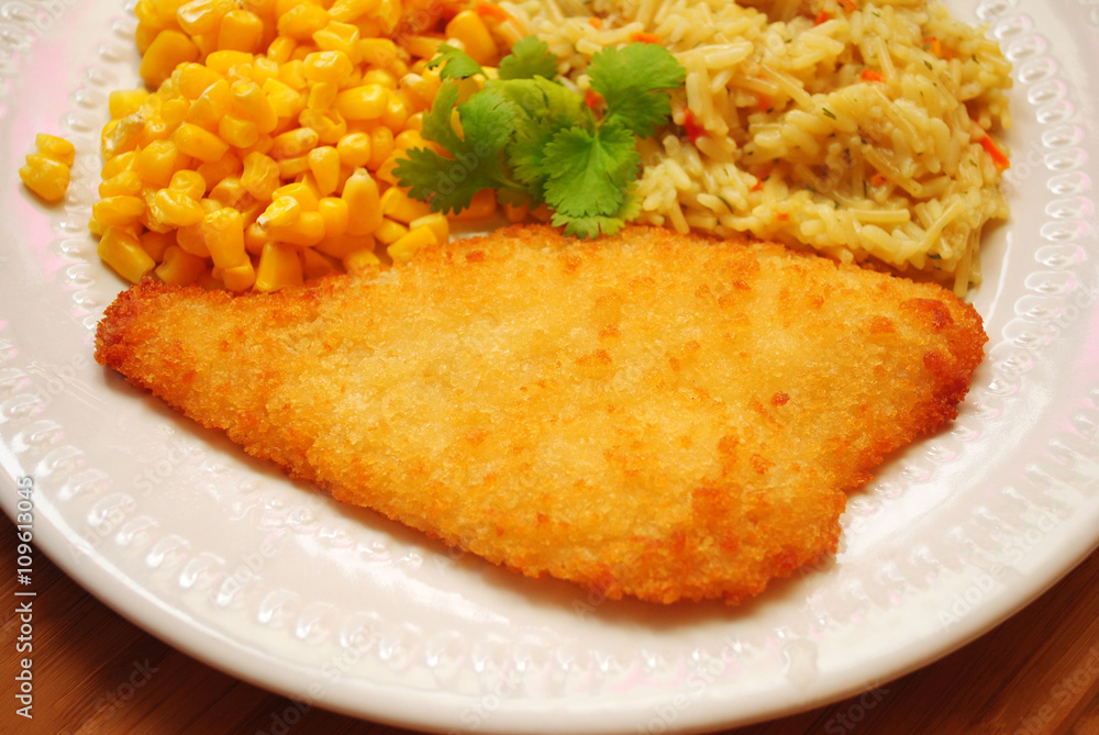 Breaded Baked Fish Served with Corn & Rice Breaded Baked Fish Served with Corn & Rice