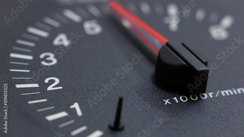 Close up shot of real tachometer with the pointer going to maximum value. Not animation. Shallow DOF