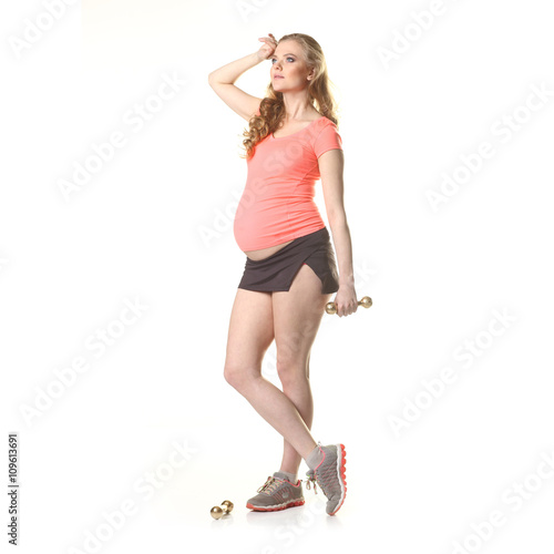 Pregnant woman in for sports. Pregnant woman doing exercise with dumbbells. Pregnant woman exercising with training weights © ruslimonchyk