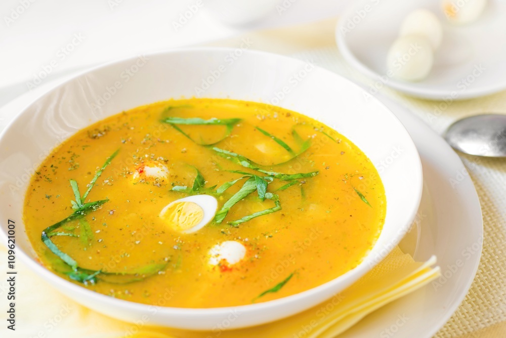 Vegetable soup with asparagus, quail egg and bear garlic