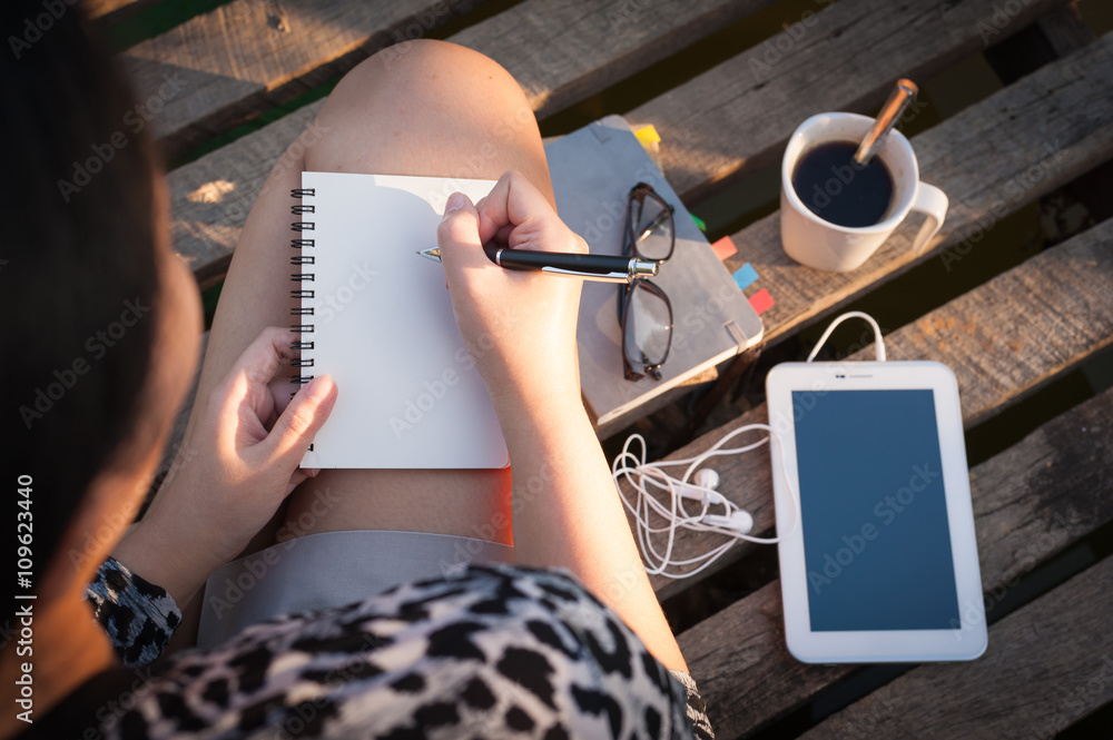 Young woman writing journal Young woman writing journal
