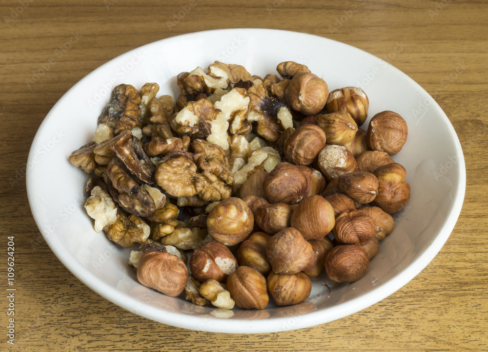 Nuts in plate on table Nuts in plate on table