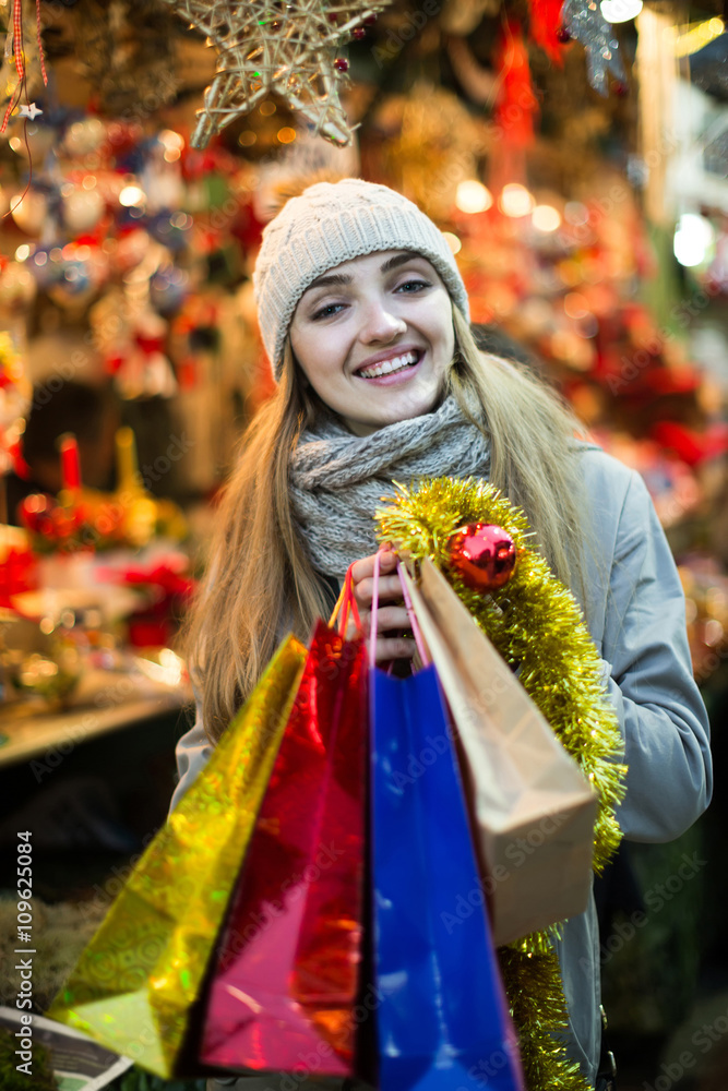 woman shopping at Christmas fair before Xmas in evening time