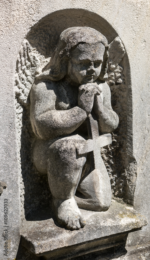 Old statue on grave Old statue on grave