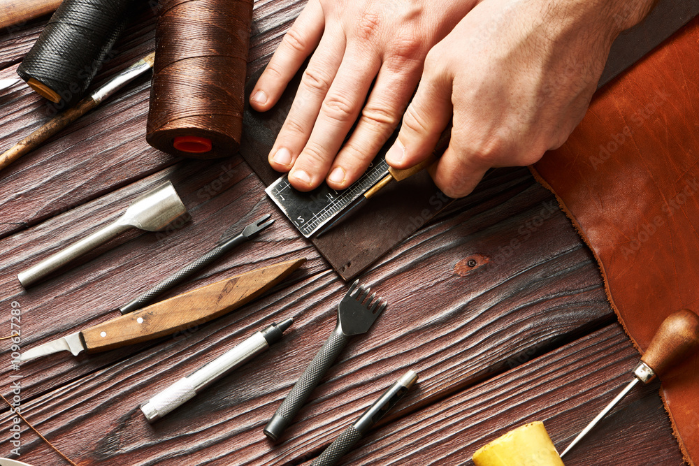Fototapeta premium Man working with leather