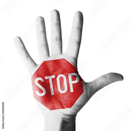 Hand raised gesture with stop sign painted, concept - isolated on white background photo