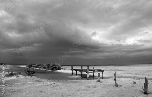 Abandoned Deteriorating Boat Dock in Chacmuchuk Lagoon next to Isla Blanca Cancun Mexico - quite a popular area for kiteboarding with a parasail photo