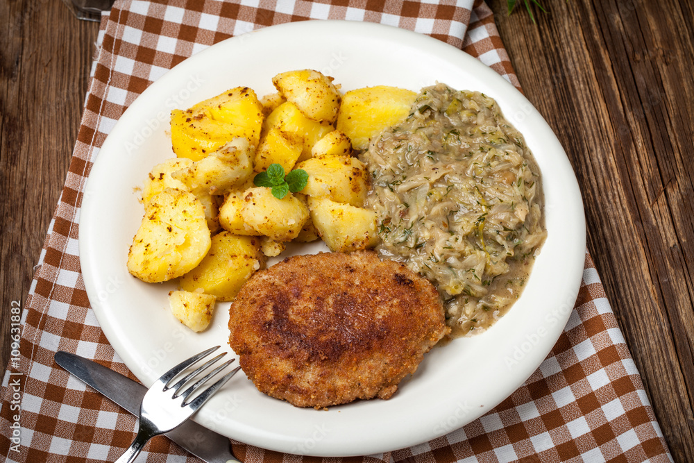 Delicious meal of minced meat cutlet, potatoes and fried cabbage Delicious meal of minced meat cutlet, potatoes and fried cabbage
