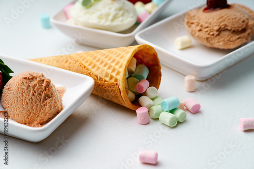 Ice cream sundae and waffle cone with candies