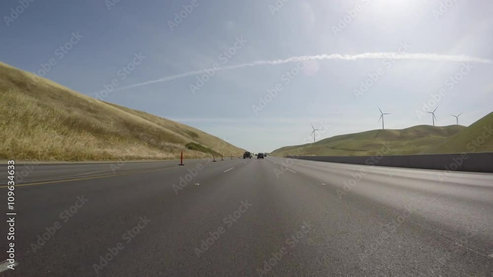 Freeway driving shot past windmills and golden hills in the Altamont Pass near Oakland, California. Freeway driving shot past windmills and golden hills in the Altamont Pass near Oakland, California.