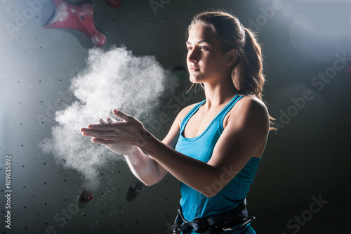 Photography Climber woman coating her hands in powder chalk magnesium