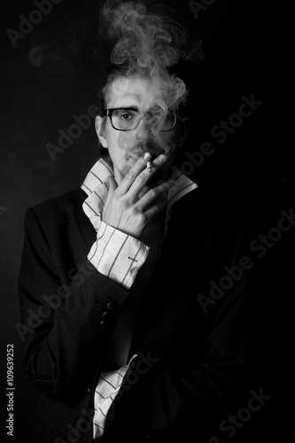 young man in glasses with cigarette
