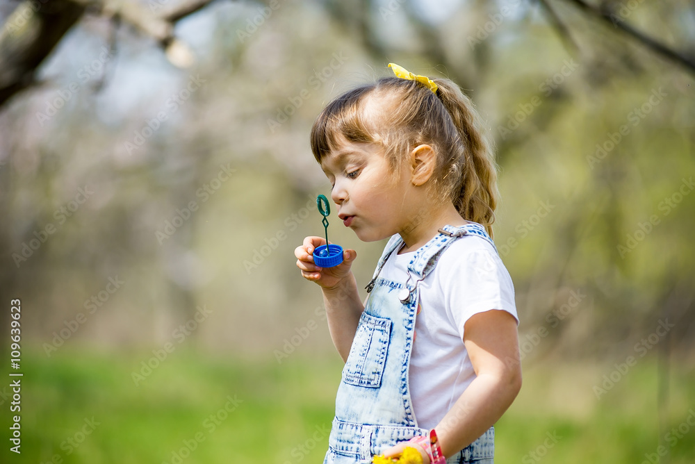 little girl inflates soap bubbles little girl inflates soap bubbles