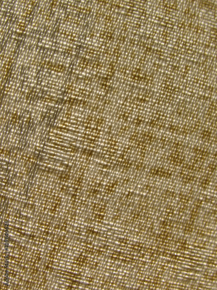 Beige textile texture closeup against the light Beige textile texture closeup against the light