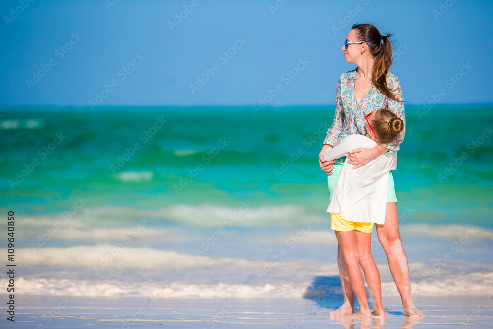 Little girl and young mother during beach vacation Little girl and young mother during beach vacation