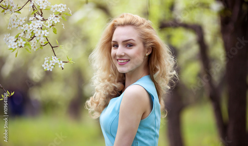 Beautiful young blonde woman in spring portrait of young lovely woman in spring flowers