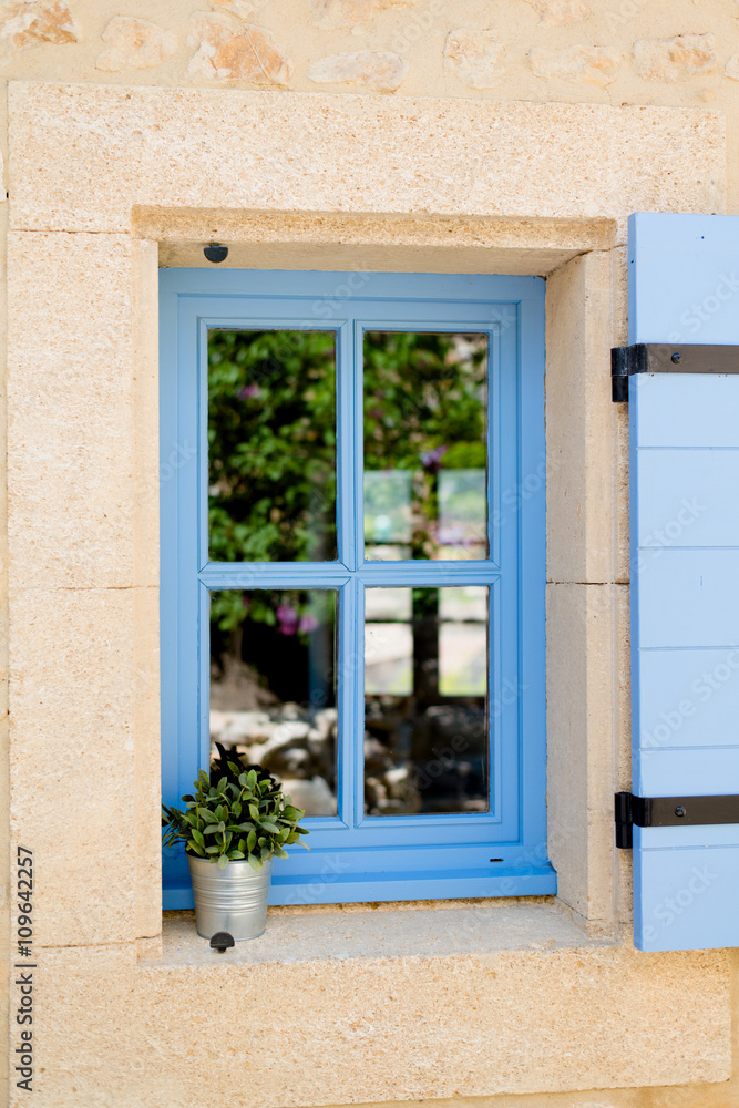 blue old window in traditional french provence architecture