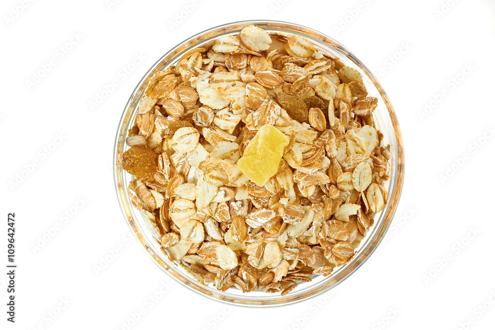 Muesli breakfast in glass bowl on white background Muesli breakfast in glass bowl on white background